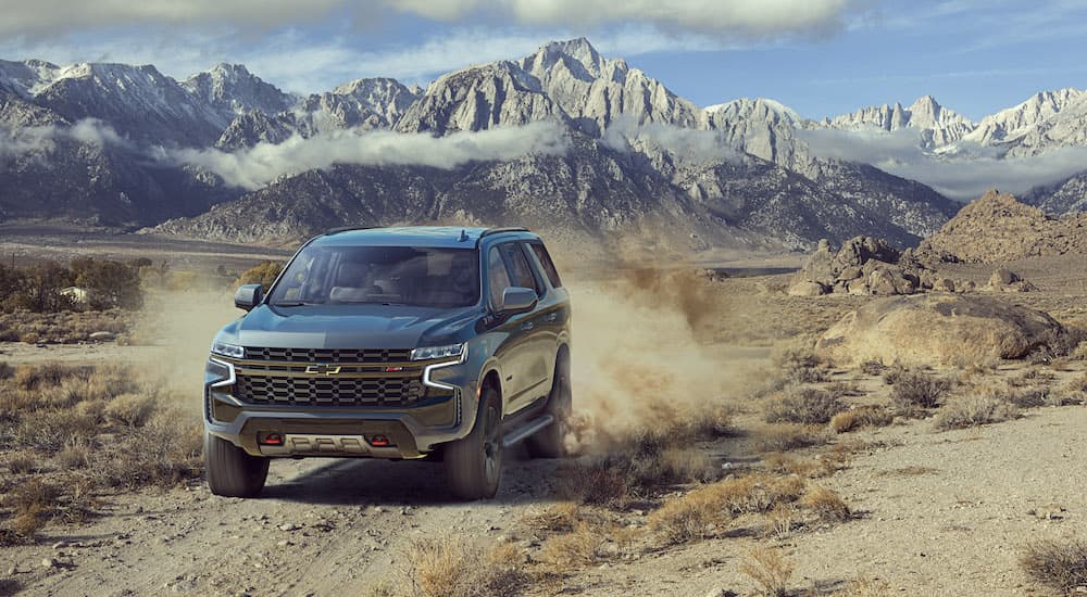 A 2022 Chevy Tahoe Z71 is shown from the front while driving off-road after leaving a Chevrolet Tahoe dealer.