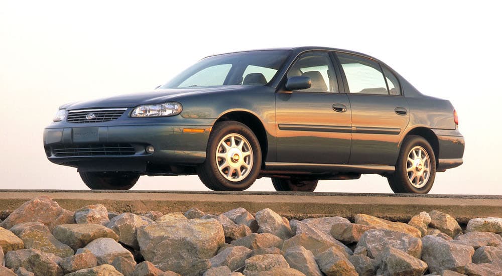 A green 1997 Chevy Malibu is shown from the side.