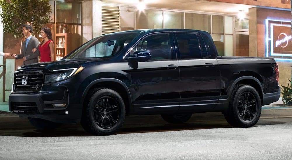 A black 2023 Honda Ridgeline Black Edition is shown from the side on a city street.