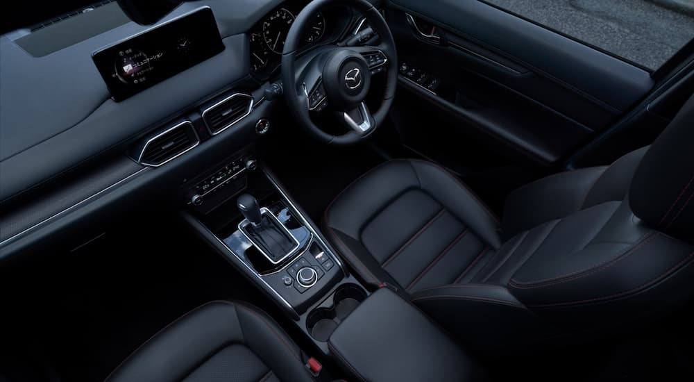 The black leather interior is shown in a 2023 Mazda CX-5 after leaving a Mazda dealer.