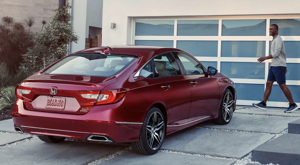 A red 2021 Honda Accord Touring 2.0T is shown parked in a driveway after searching 'online Honda Accord sales.'