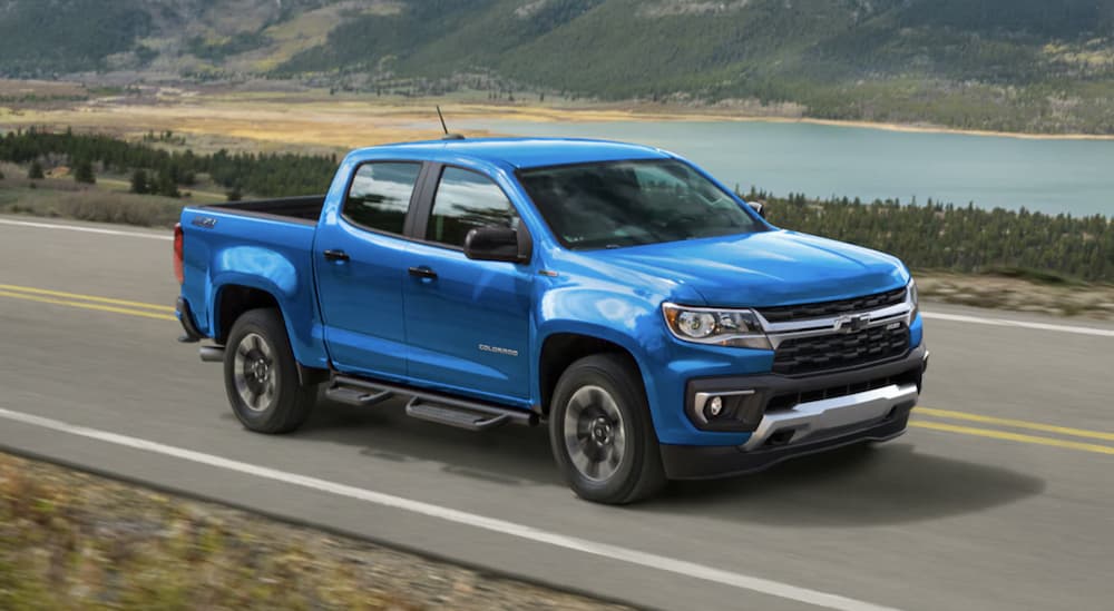 A blue 2022 Chevy Colorado is shown driving on an open road.