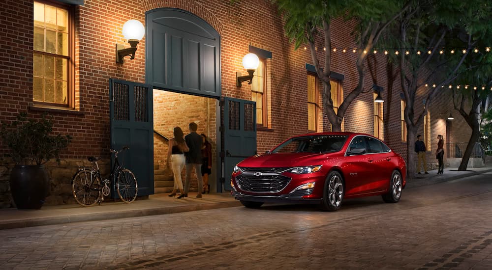 A red 2023 Chevy Malibu is shown from the front at an angle.