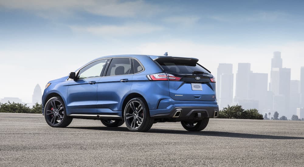 A blue 2019 Ford Edge ST is shown from the rear at an angle.