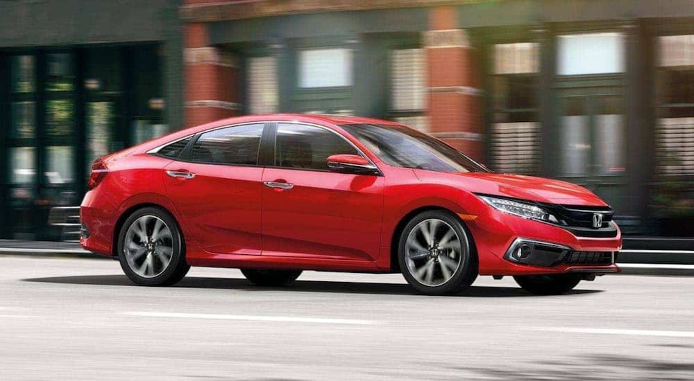 A red 2020 Honda Civic Sedan is shown from the side.