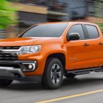 An orange 2021 Chevy Colorado Z71 is shown from the front at an angle.