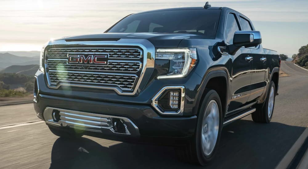 A grey 2021 GMC Sierra 1500 Denali is shown from the front after leaving a certified used truck dealer.