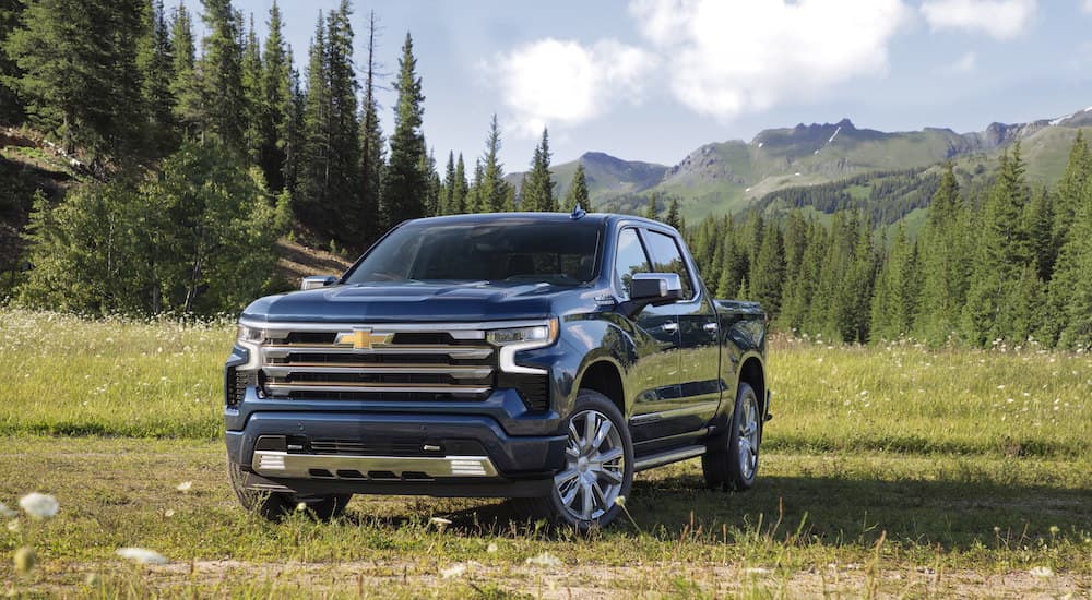 A blue 2022 Chevy Silverado 1500 High Country is shown from the front at an angle.