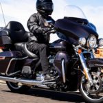 A black 2022 Harley-Davidson Ultra Limited is shown driving on an open highway.