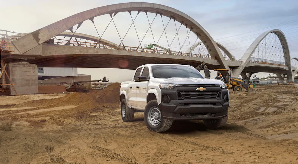 A white 2023 Chevy Colorado WT is shown from the front at an angle after leaving a dealer that has fleet trucks for sale.