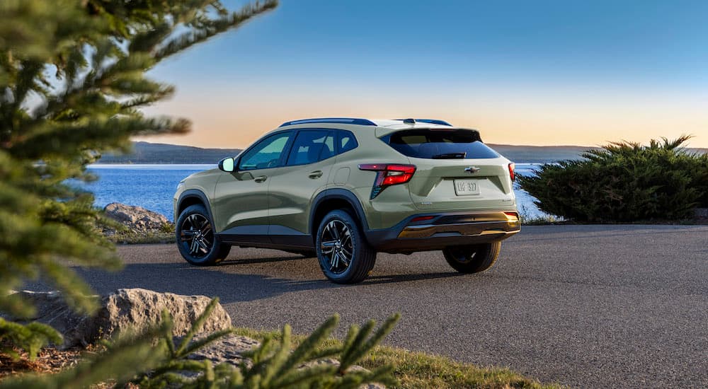 A green 2024 Chevy Trax Activ is shown from the rear at an angle.