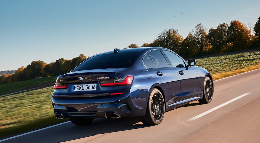 A blue 2023 BMW M340D is shown from the rear at an angle.