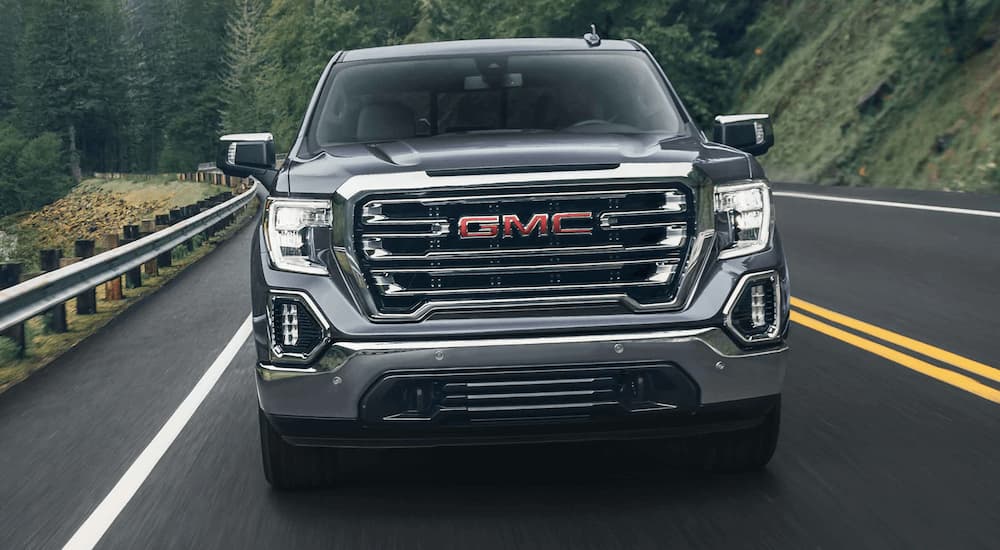 A grey 2022 GMC Sierra 1500 is shown from the front after viewing used work trucks for sale.