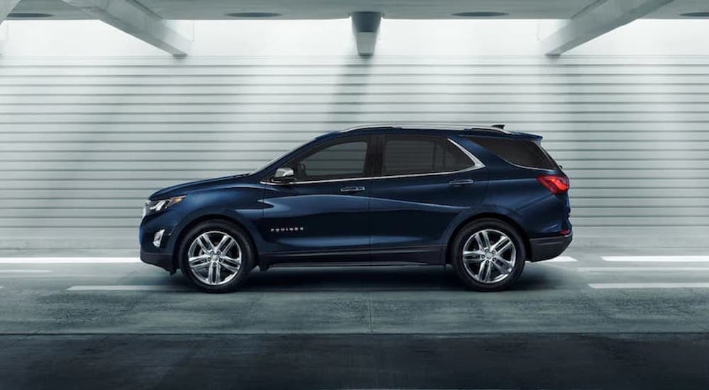 A popular certified Chevy for sale, a blue 2021 Chevy Equinox, is shown from the side.