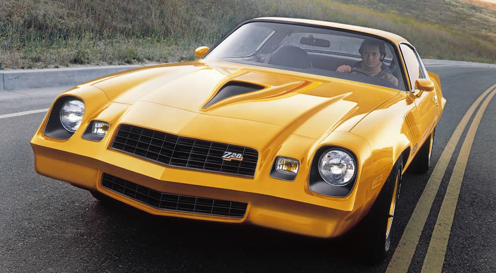 A yellow 1978 Chevy Camaro Z28 is shown from the front.
