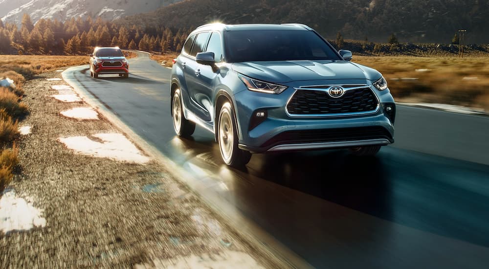 A blue 2020 Toyota Highlander is shown from the front after leaving a used SUV dealer.