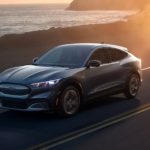 A grey 2021 Ford Mustang Mach E is shown from the front at an angle.