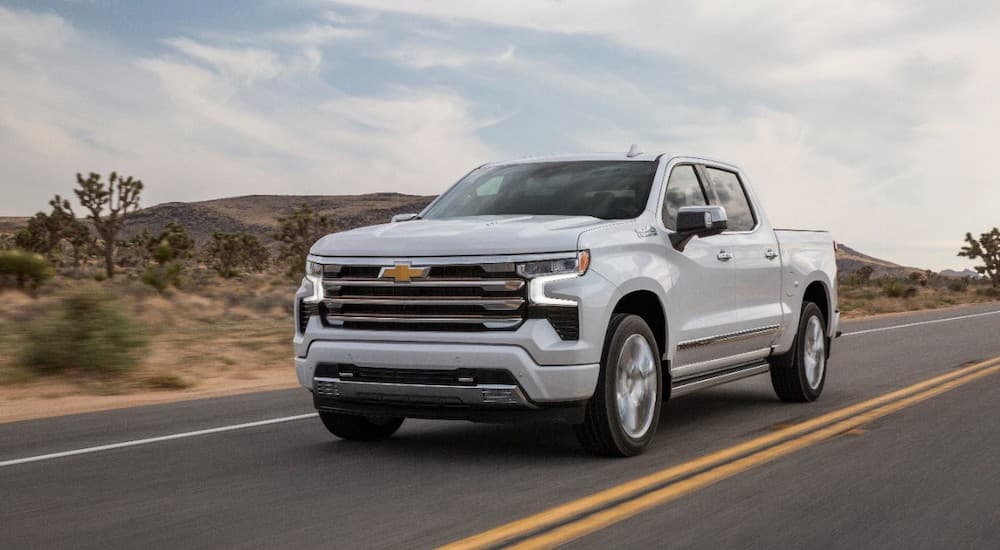 A white 2022 Chevy Silverado 1500 High Country is shown from the front at an angle.