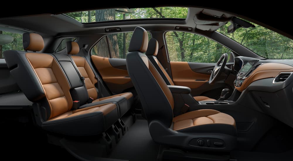 The black and brown leather interior is shown in a 2023 Chevy Equinox.
