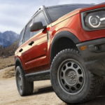 A red 2023 Ford Bronco Sport is shown in close up.