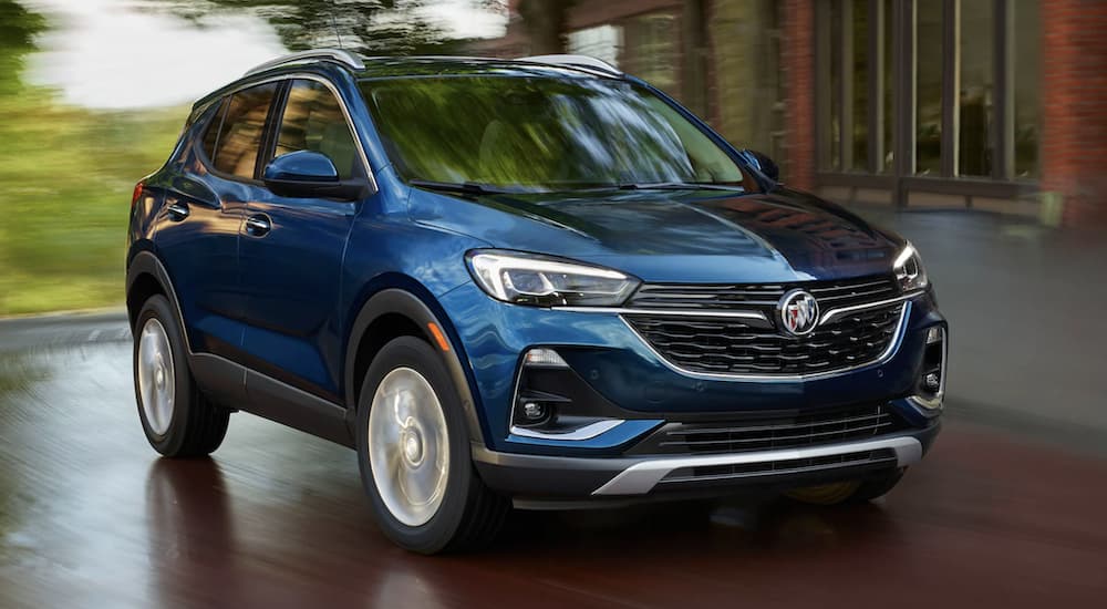 A blue 2022 Buick Encore GX is shown from the front rounding a corner after leaving a Buick dealer near you.