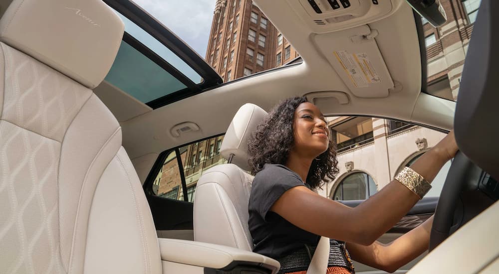 A woman is shown driving a 2022 Buick Envision to a Buick Envision dealer.