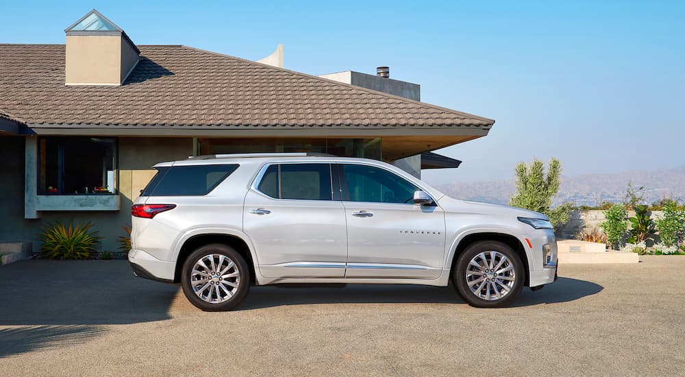 A silver 2023 Chevy Traverse is shown form the side parked on a driveway.