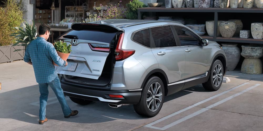 A silver 2022 Honda CR-V Touring is shown while being loaded with plants.