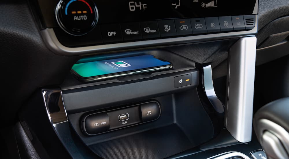 A phone is shown charging in a 2022 Kia Seltos.