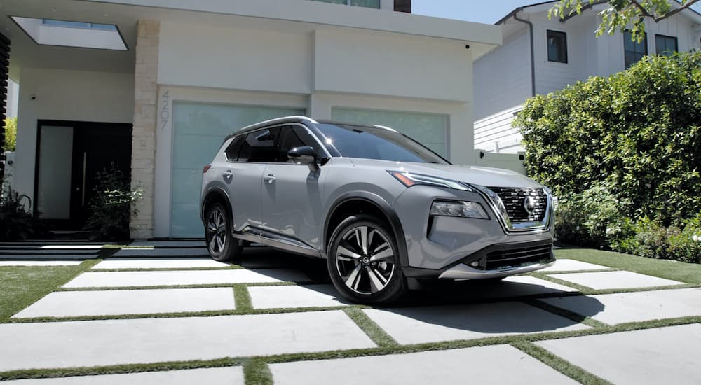 A silver 2021 Nissan Rogue S is shown parked in a driveway.