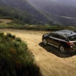 A black 2017 Subaru Outback is shown from a high angle on a mountain trail.