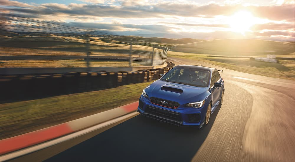 A dark blue 2019 Subaru WRX STI Type RA is shown on a race track after looking at used Subarus for sale.
