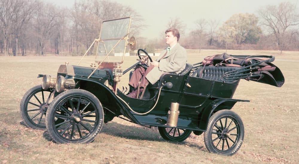 A green 1908 Ford Model T is shown from the side.