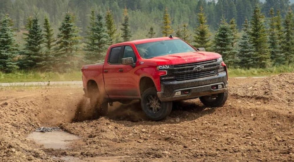 A red 2020 Chevy Silverado 1500 Trail Boss is shown from the front at an angle after leaving a Chevy Silverado dealer.
