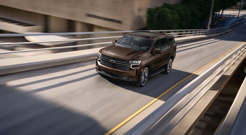 A brown 2022 Chevy Tahoe is shown from the front at an angle after leaving a Chevy dealership.