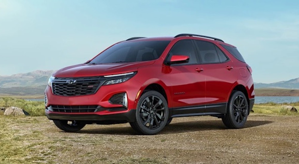 A red 2023 Chevy Equinox RS is shown from the side at an angle.