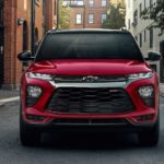 A red 2023 Chevy Trailblazer RS is shown from the front on a city street.