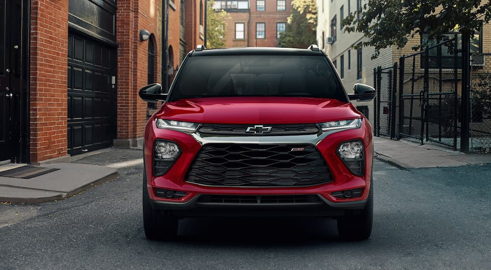 A red 2023 Chevy Trailblazer RS is shown from the front on a city street.