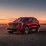 A red 2023 Cadillac XT4 is shown from the front at an angle.