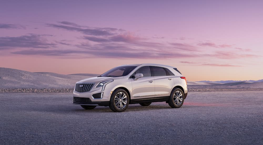 A white 2023 Cadillac XT5 is shown from the side at an angle.