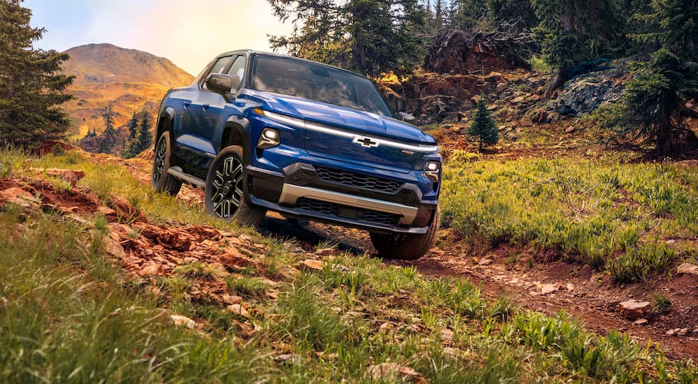 A blue 2024 Chevy Silverado EV is shown from the front.