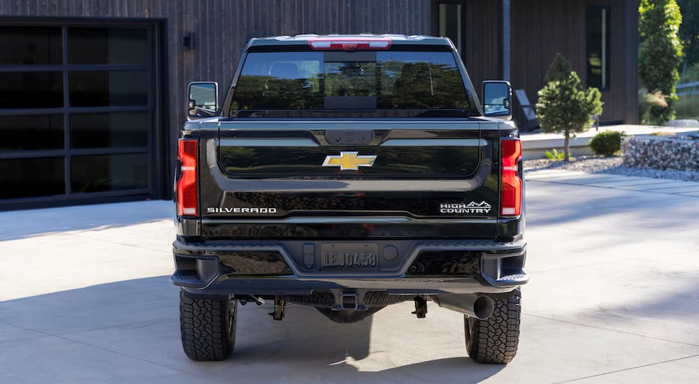 A black 2024 Chevy Silverado 2500HD High Country is shown from the rear.