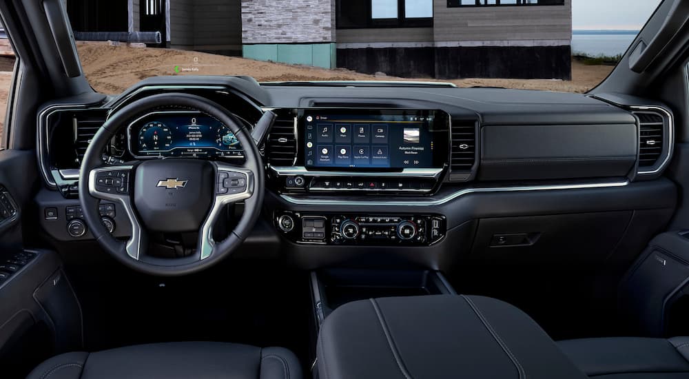 The black interior of a 2024 Chevy Silverado 3500 HD is shown from the driver's seat.