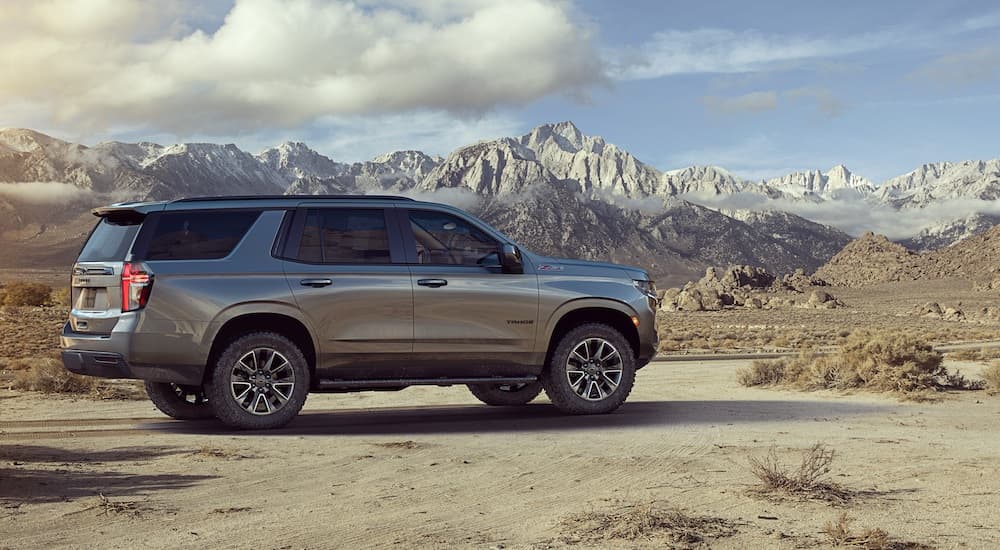 A silver 2023 Chevy Tahoe Z71 is shown from the side while off-road.