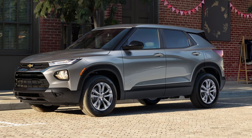 A silver 2023 Chevy Trailblazer is shown from the side parked on the side of a city street.