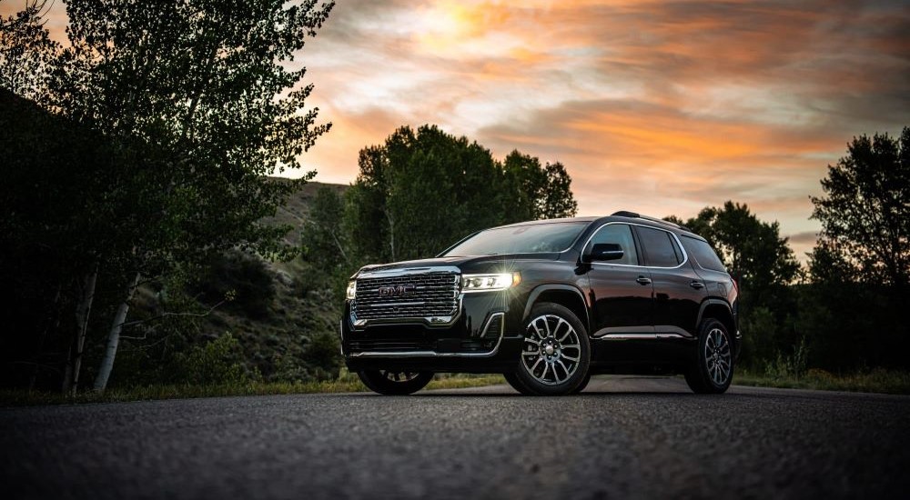 A black 2020 GMC Acadia Denali is shown at sunset.