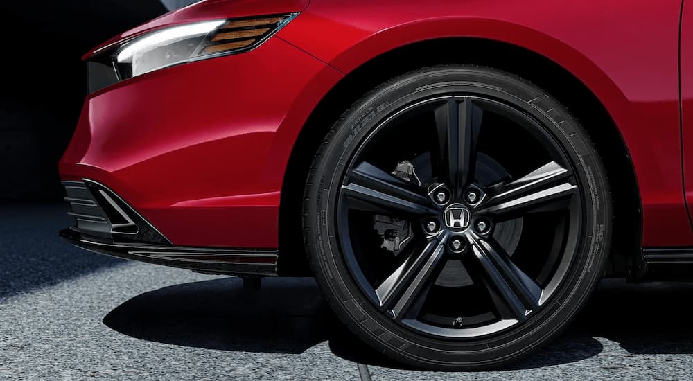 The front half of a red 2023 Honda Accord Sport Hybrid is shown at a Honda Accord dealership.