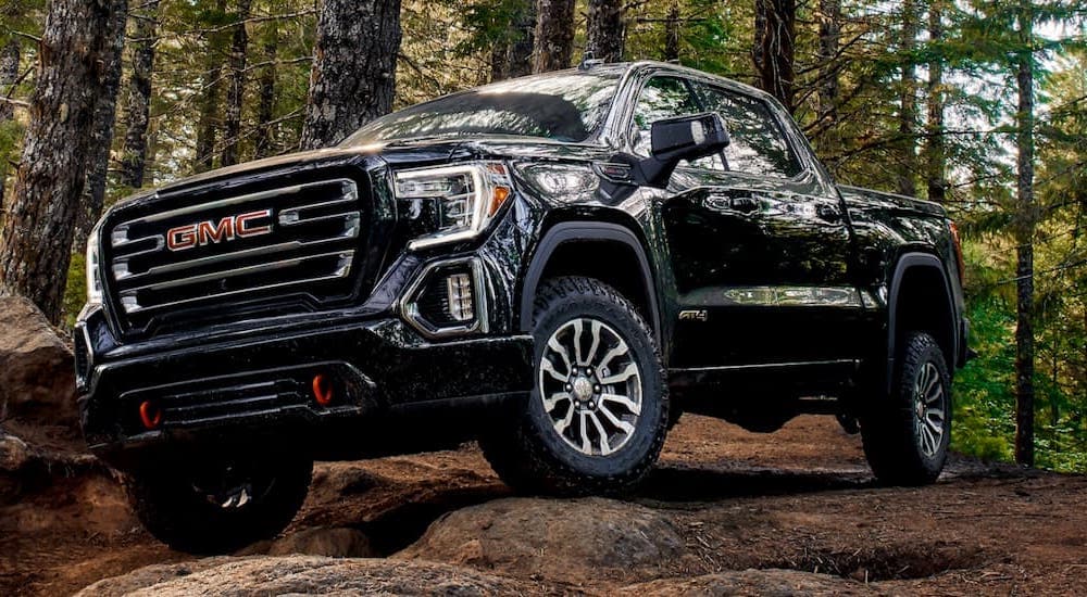 A black 2019 GMC Sierra AT4 is shown from the front at an angle.