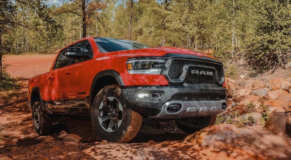 A red 2022 Ram 1500 Rebel is shown from the front at an angle while off-road.