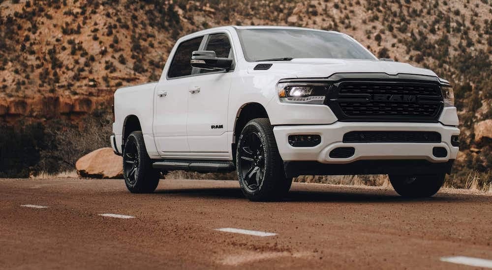 A white 2022 Ram 1500 is shown from the front at an angle during a 2023 Ford F-150 vs 2023 Ram 1500 comparison.